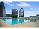 Rooftop pool surrounded by lounge chairs with city views at 3324 Peachtree Ne Rd # 2718, Atlanta, GA 30326