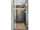 Modern shower with horizontally laid dark brown tiling, glass door, and brown tiled shower floor at 3324 Peachtree Ne Rd # 2718, Atlanta, GA 30326
