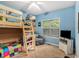 Cozy bedroom with a bunk bed, window view, and blue walls, creating a fun and inviting space at 104 Streambank Ct, Temple, GA 30179