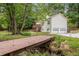 Beautiful home exterior featuring a bridge, lush landscaping, and a convenient two-car garage at 104 Streambank Ct, Temple, GA 30179