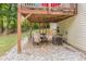 Inviting covered patio with dining set, ideal for outdoor gatherings in a serene setting at 104 Streambank Ct, Temple, GA 30179