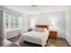 Bright bedroom with wood floors, large window, and neutral decor at 609 Mill Pond Se Dr, Smyrna, GA 30082