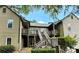 Multi-level condo exterior featuring wood siding, decks, and staircase at 609 Mill Pond Se Dr, Smyrna, GA 30082