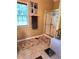 Well-lit bathroom featuring a shower, a large window, and a decorative area rug at 6561 Harrington Pl, Douglasville, GA 30135