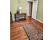 Bedroom featuring wood floors, console table with wicker baskets, and white door at 6561 Harrington Pl, Douglasville, GA 30135