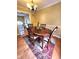 Cozy dining room featuring hardwood floors, a decorative rug, and a stylish chandelier at 6561 Harrington Pl, Douglasville, GA 30135