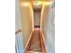 Hallway with hardwood floors and patterned runner leading to a white door at 6561 Harrington Pl, Douglasville, GA 30135