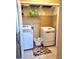 Bright laundry room with washer, dryer, storage shelves and a floral rug at 6561 Harrington Pl, Douglasville, GA 30135