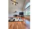 Sunlit living room boasts a fireplace, arched window, and hardwood floors at 6561 Harrington Pl, Douglasville, GA 30135
