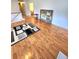 Bright living room with wood floors, area rug, artwork and staircase at 6561 Harrington Pl, Douglasville, GA 30135