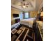 The main bedroom has a tray ceiling, a large bed, and a decorative area rug at 6561 Harrington Pl, Douglasville, GA 30135