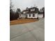 House exterior with landscaping and a circular driveway at 3730 Reserve Overlook (Lot 8) Way, Cumming, GA 30041