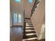 Elegant staircase with dark wood railing and carpet at 3730 Reserve Overlook (Lot 8) Way, Cumming, GA 30041