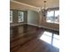 Formal dining room featuring hardwood floors, archway into other rooms, modern chandelier, and plenty of natural light at 245 Fountain Oak Way, Canton, GA 30114