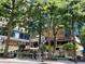 Lively street view with restaurants and outdoor seating under mature shade trees at 75 14Th Ne St # 4150, Atlanta, GA 30309