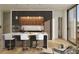 Modern kitchen with an island, white chairs, wooden cabinets, and stainless steel appliances at 318 Sandy Springs Cir # 270, Sandy Springs, GA 30328
