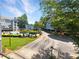 Aerial view of condo community, showcasing a swimming pool, green spaces, and tree lined streets at 311 Granville Ct, Atlanta, GA 30328