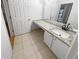Bathroom with granite countertops, a modern sink, and white cabinets with brushed nickel hardware at 311 Granville Ct, Atlanta, GA 30328