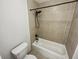 Clean, tiled bathroom featuring a shower and tub combination and a modern toilet at 311 Granville Ct, Atlanta, GA 30328