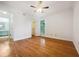 Spacious bedroom featuring gleaming hardwood floors, a ceiling fan and an ensuite bathroom with a walk-in closet at 311 Granville Ct, Atlanta, GA 30328