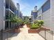 Beautiful condo complex with mature trees and manicured landscaping featuring brick planters and metal fencing at 311 Granville Ct, Atlanta, GA 30328