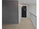 Condo entrance with walkway, siding, exterior light fixture, and the unit number on the door at 311 Granville Ct, Atlanta, GA 30328
