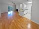 Open-concept living area with hardwood floors connects to kitchen and balcony with natural light at 311 Granville Ct, Atlanta, GA 30328