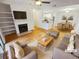 Bright, staged living room with fireplace, ceiling fan, and open floor plan at 311 Granville Ct, Atlanta, GA 30328