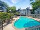 Resort-style community pool surrounded by mature trees and lounge chairs at 311 Granville Ct, Atlanta, GA 30328