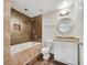 Modern bathroom featuring a tiled shower and bathtub combo, complemented by a granite countertop vanity and hardwood floors at 89 Elsberry Rd, Dallas, GA 30157