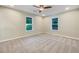 Bright bedroom featuring neutral carpet, ceiling fan and two windows providing lots of natural light at 89 Elsberry Rd, Dallas, GA 30157