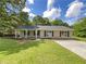 Charming single story home with a cozy front porch and well maintained lawn on a sunny day at 89 Elsberry Rd, Dallas, GA 30157
