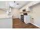 This kitchen features white cabinets, stainless steel appliances, and wood flooring at 89 Elsberry Rd, Dallas, GA 30157
