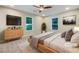 Cozy main bedroom with carpet, ceiling fan, large window and dresser with drawers at 89 Elsberry Rd, Dallas, GA 30157