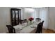 Formal dining room with chandelier, table setting and hardwood floors at 10785 Arlington Pt, Alpharetta, GA 30022