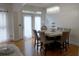 Bright dining room with hardwood floors and a marble table at 10785 Arlington Pt, Alpharetta, GA 30022