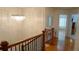 Elegant upstairs hallway with hardwood floors and chandelier at 10785 Arlington Pt, Alpharetta, GA 30022