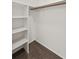 Walk-in closet features wood floors, shelving, and a rod for organized storage at 707 Augusta Se Dr, Marietta, GA 30067