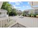 View from the deck of a two-story home, featuring white railings and views of other homes and trees at 707 Augusta Se Dr, Marietta, GA 30067