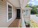 Condo entrance featuring a wooden porch, black front door, and beautiful window details at 707 Augusta Se Dr, Marietta, GA 30067