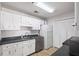 Bright kitchen featuring white cabinets, stainless steel appliances and sleek countertops at 707 Augusta Se Dr, Marietta, GA 30067