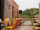 Outdoor patio with colorful chairs and tables, perfect for dining al fresco at 499 Godfrey Dr, Cumming, GA 30040