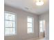 Light-filled bedroom with double windows and attached bathroom at 145 Cedarwood Ln, Roswell, GA 30075