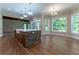 Island kitchen features a large island with stone accents and hardwood floors at 971 Heathchase Dr, Suwanee, GA 30024