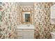 Charming bathroom with floral wallpaper and white vanity at 5622 Williamsburg Dr, Norcross, GA 30093