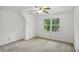 Simple bedroom with neutral walls, carpet flooring and a window at 5622 Williamsburg Dr, Norcross, GA 30093