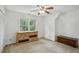 Spacious bedroom with dresser, chest, window, and ceiling fan at 5622 Williamsburg Dr, Norcross, GA 30093