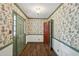 Entryway with hardwood floors and floral wallpaper, offering a charming welcome at 5622 Williamsburg Dr, Norcross, GA 30093