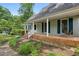 Brick front porch with a wooden swing, showcasing curb appeal at 5622 Williamsburg Dr, Norcross, GA 30093