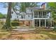 Home's back features a large sunroom and flagstone patio at 5622 Williamsburg Dr, Norcross, GA 30093